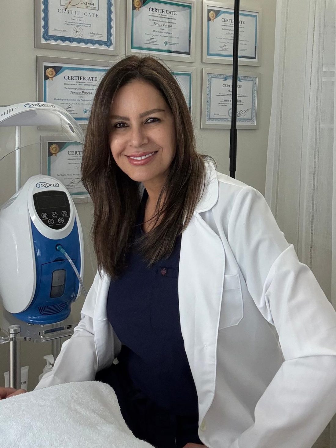 Teresa Pareja in her Miami treatment room with her training certificates